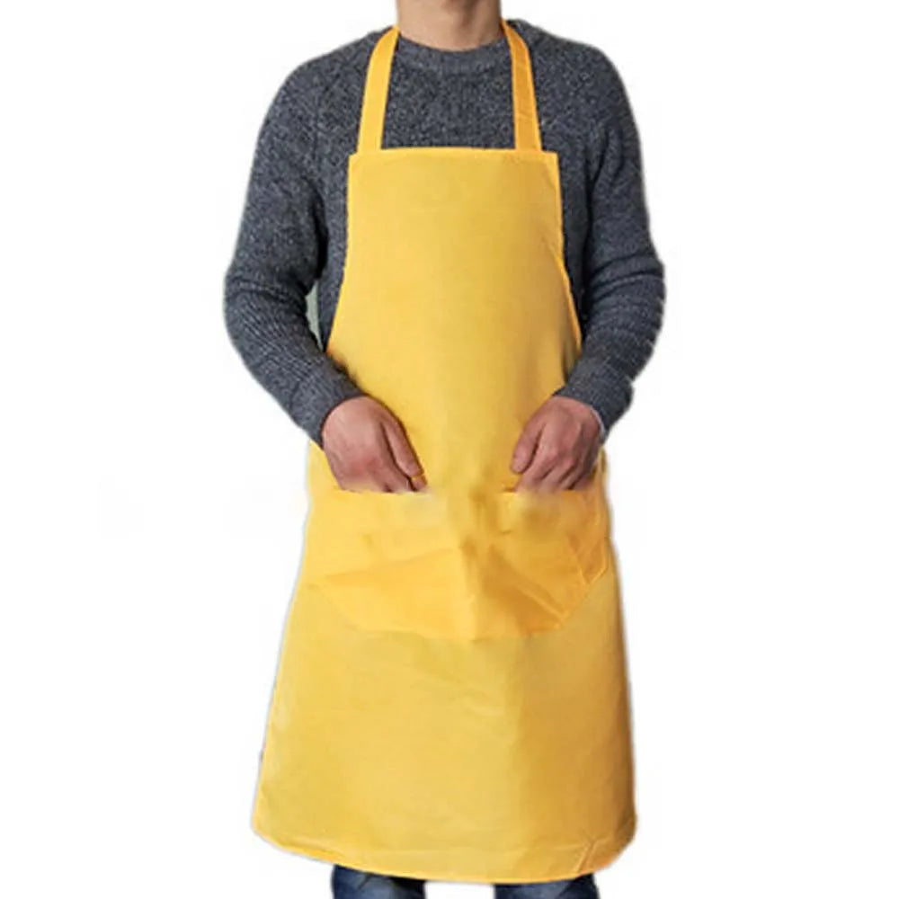 A person wearing a yellow waterproof kitchen apron over a gray sweater.