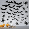 A collection of black bat silhouettes and spiders are displayed as wall stickers for Halloween décor.