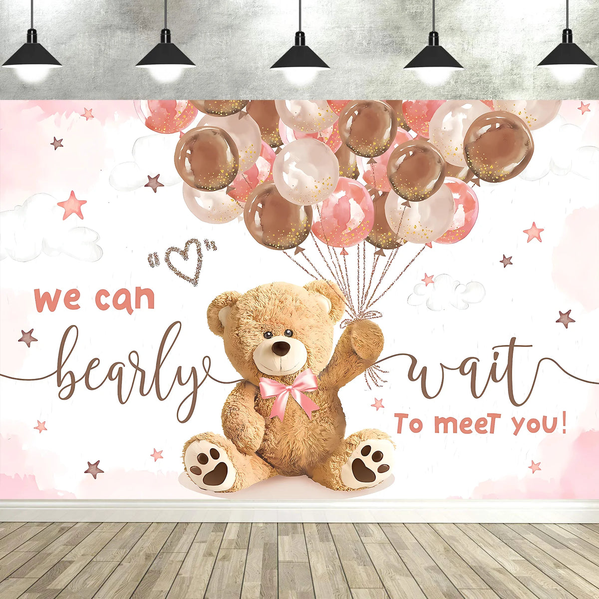 A pink and white photo backdrop featuring a teddy bear and balloons with the text we can barely wait to meet you