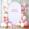 A white arch backdrop decorated with pink and gold balloons for a birthday party