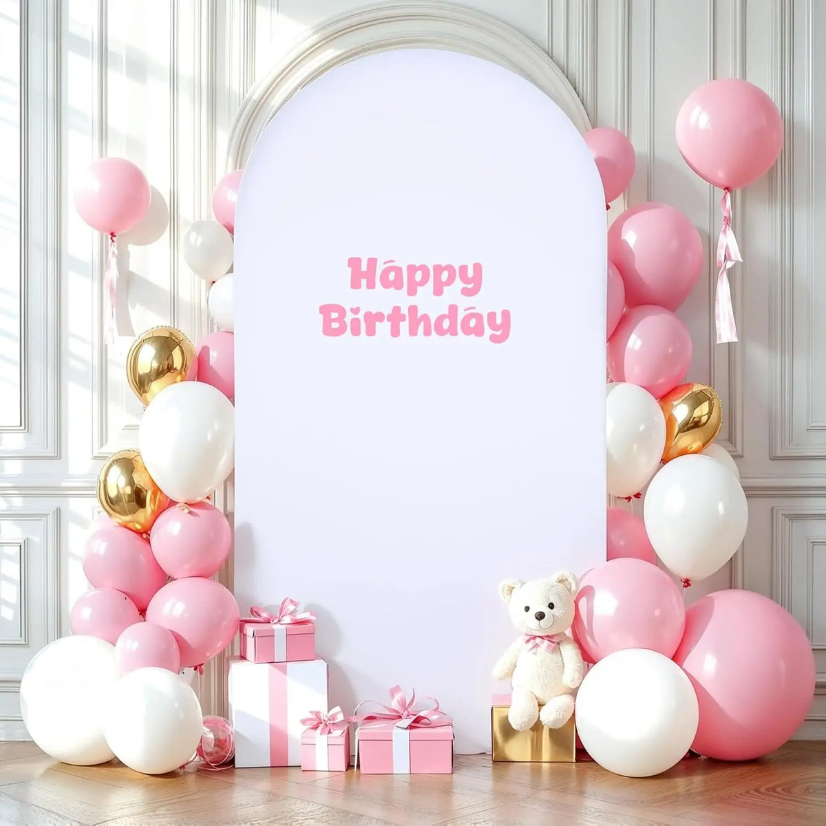 A white arch backdrop decorated with pink and gold balloons for a birthday party
