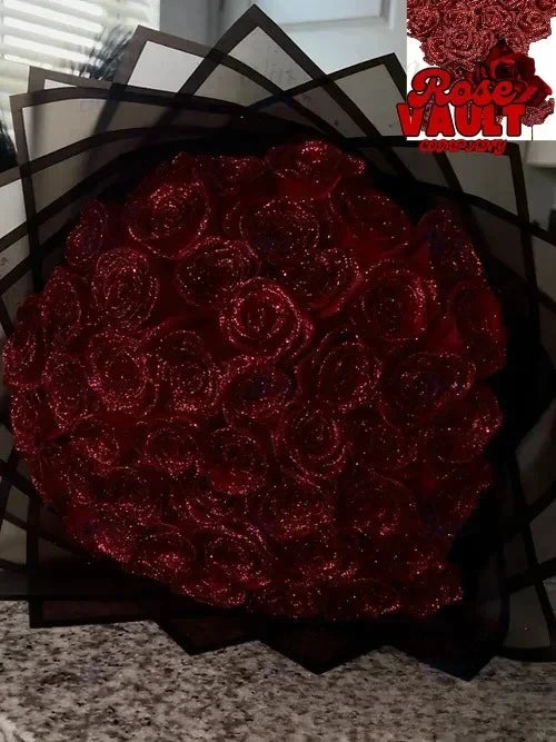 A bouquet of deep red glitter artificial roses displayed against a dark background.