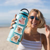 A woman holds a teal insulated water bottle with a cat decal on it outdoors.