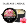 A black jar candle labeled Massage Candle Geranium with a pink geranium flower visible.