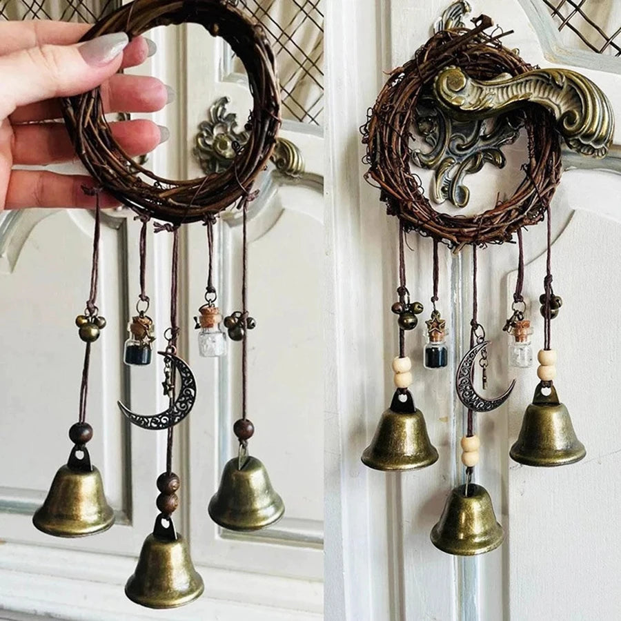 A set of rustic metal decorative door and window handles featuring dark wood wreaths and brass bells.