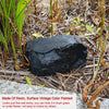 A dark, smooth stone painted with vintage color, used as a decorative garden hiding stone.