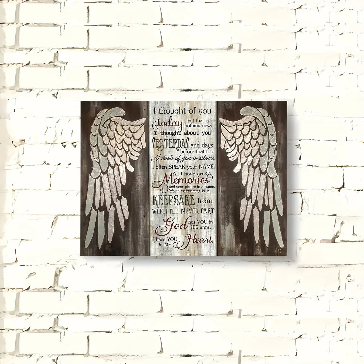Wooden wall art featuring a silhouette of wings and inspirational text on a rustic wooden background
