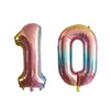 A set of foil number balloons shaped like 1 and 0 in iridescent pink and silver colors.