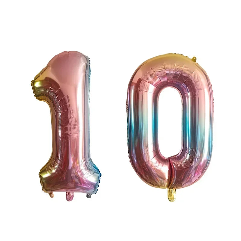 A set of foil number balloons shaped like 1 and 0 in iridescent pink and silver colors.