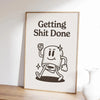 A framed black and white line drawing quote that reads Getting Shit Done on a light background.