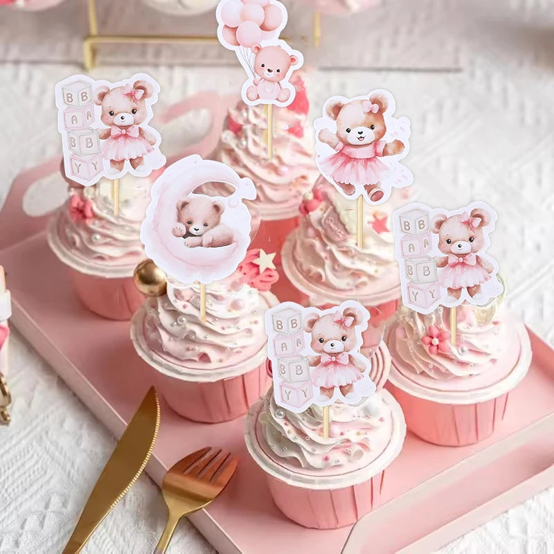 Pink cupcakes with bear toppers and frosting on a pink tray for baby shower or birthday parties