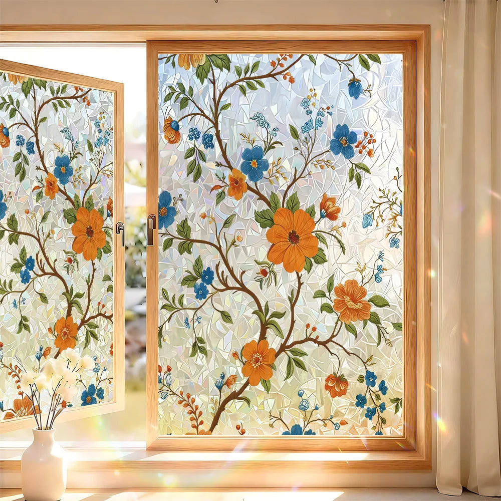 A close-up of a window featuring decorative privacy film with floral designs and UV protection.
