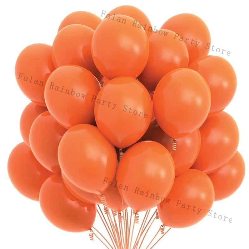 A bunch of matte orange latex balloons tied together on thin strings.