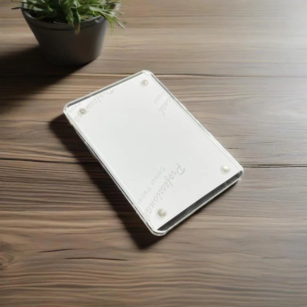 A rectangular silver photo frame with a magnetic visor clip holder resting on a wooden surface.
