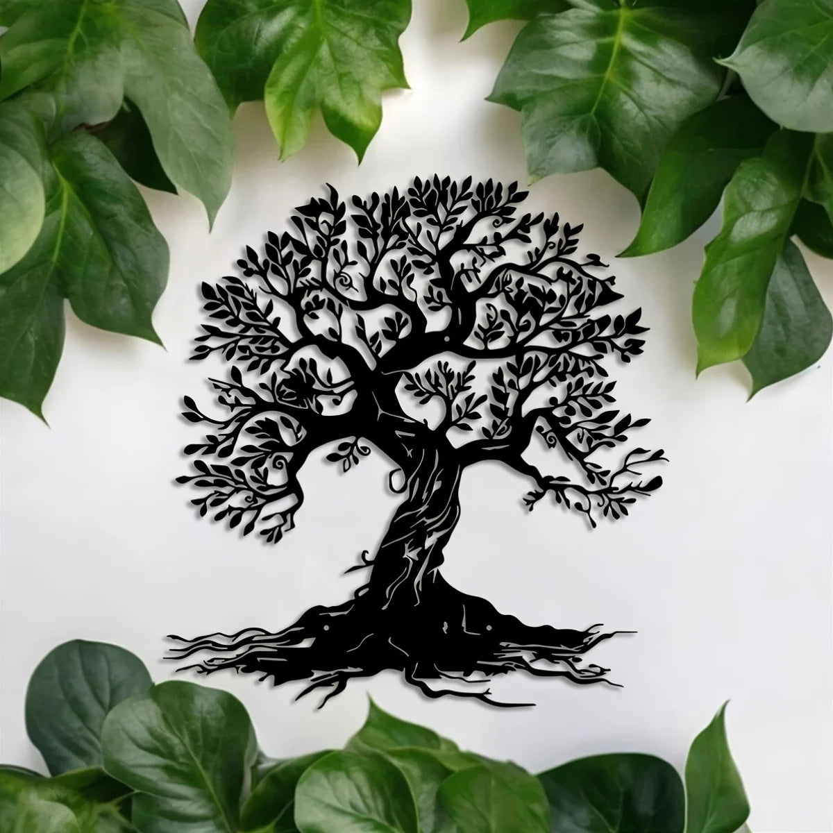 Black silhouette of a large tree with roots on a white background surrounded by green leaves