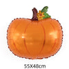 An orange pumpkin shaped foil balloon decoration with a green leaf and a brown animal figure on top.