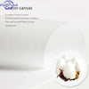 White cotton canvas fabric texture showing a close-up of the weave and soft fibers.
