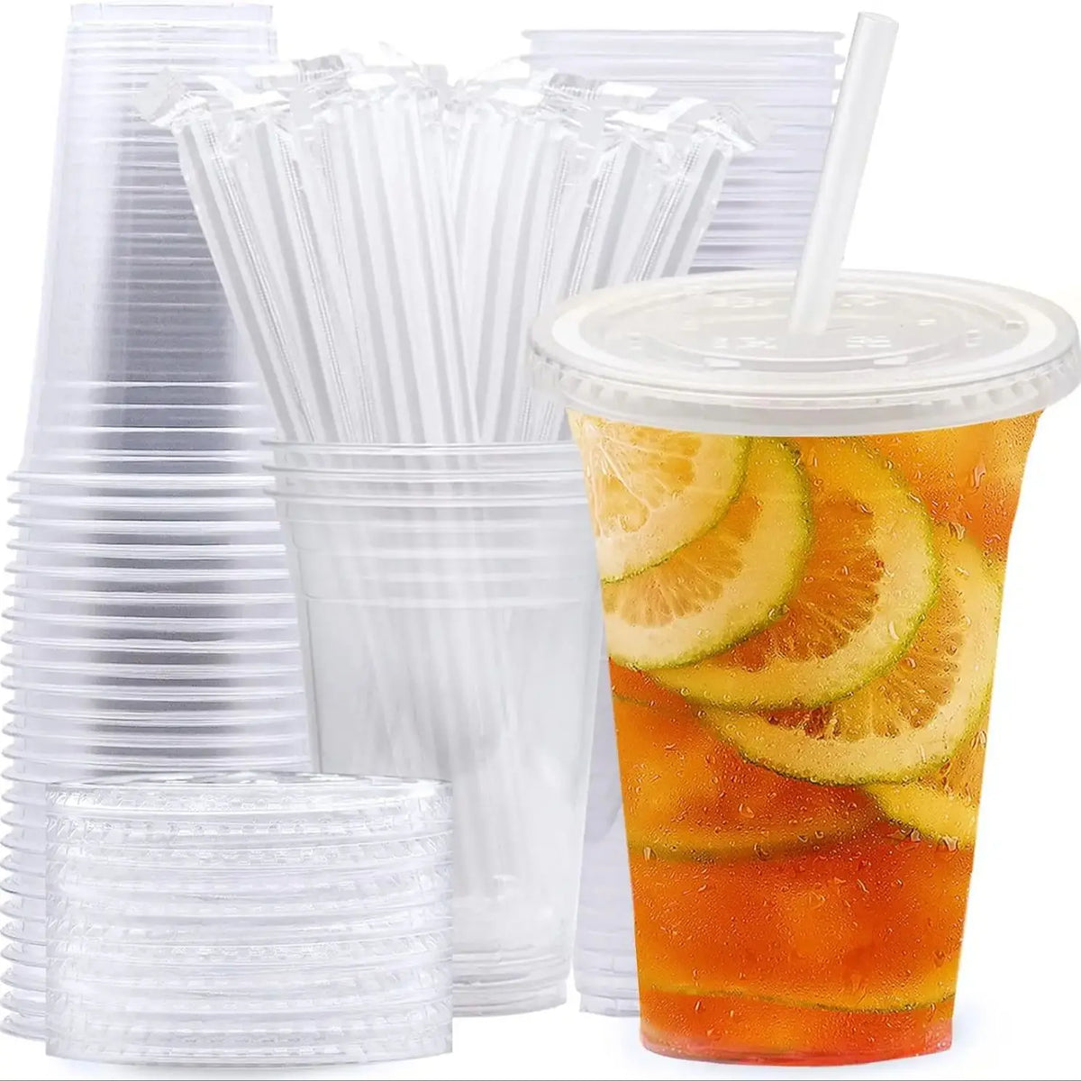 A collection of clear plastic drinking cups and straws are displayed next to a tall glass filled with orange juice.