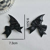 A set of black devil horn and bat wing hair clips, measuring 9.5cm long.