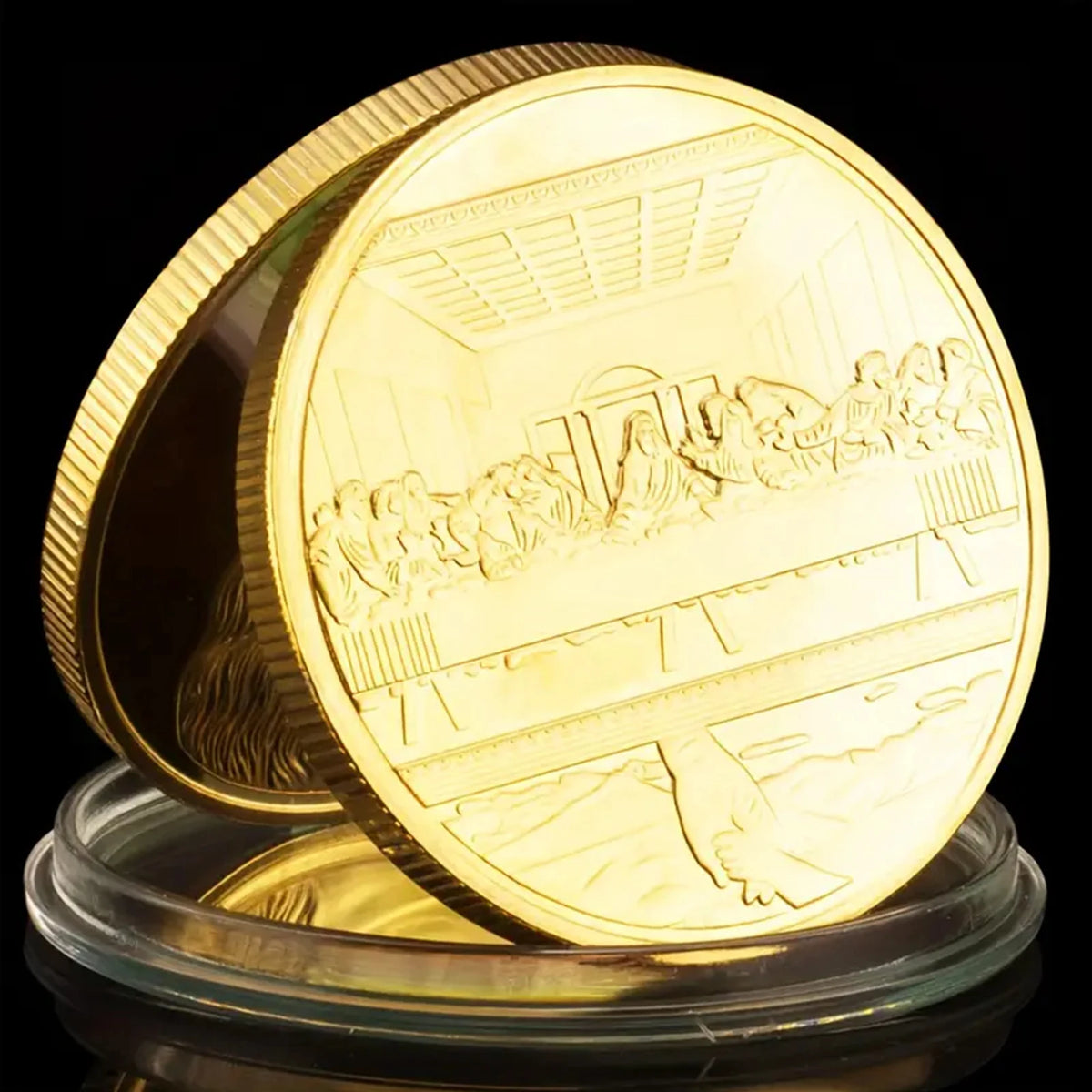 A gold commemorative metal coin depicting a scene from the Last Supper.