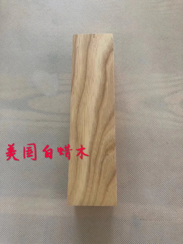 A vertical blank of light-colored natural wood, likely for knife handles or DIY projects.
