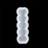 A white silicone candle mold kit with a heart-shaped design, shown against a black background.