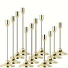 A set of twelve elegant gold-toned metal candle holders with slender stems and flared bases.