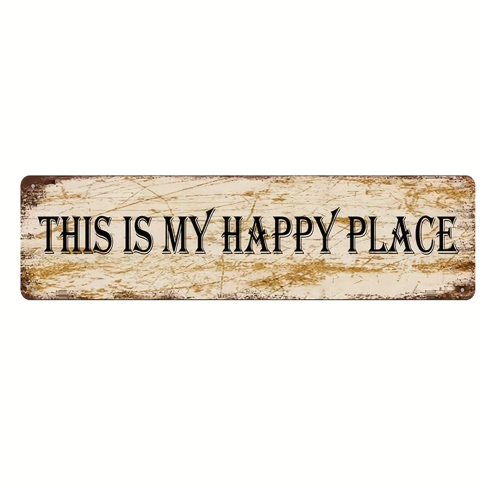 A weathered vintage metal sign with the text This is my happy place carved into it.