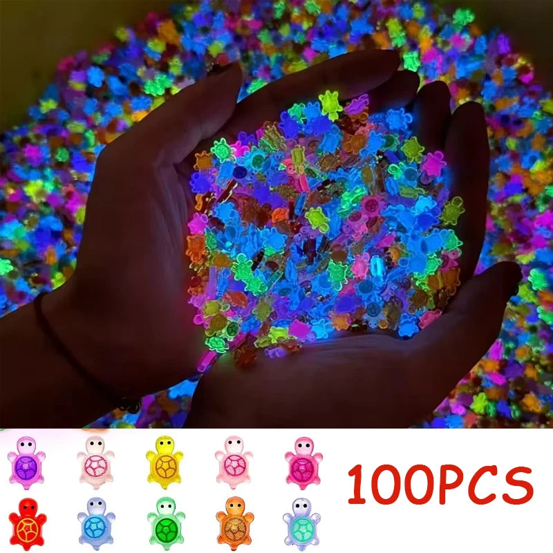 A hand holds a pile of glow-in-the-dark resin turtle figurines in various bright colors against a colorful background.