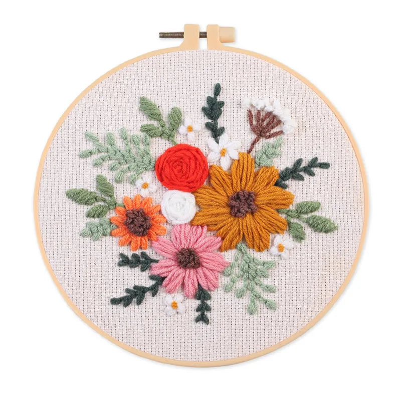Punch needle embroidery kit featuring a floral design on stamped cloth with tools