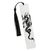A white tag with a black dragon silhouette is attached to a black tassel, used as an elegant reading accessory.