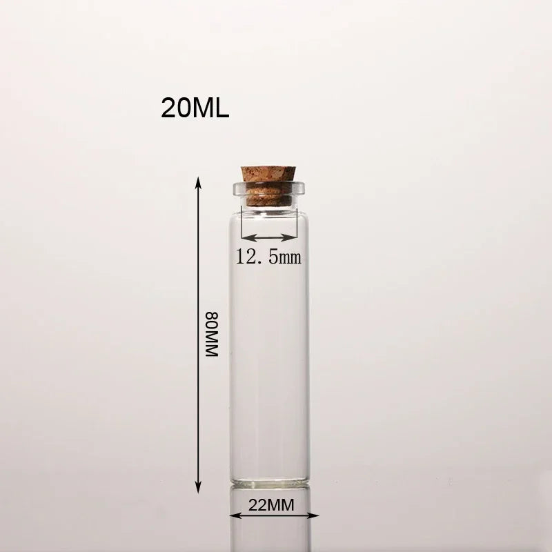 A clear glass bottle with a cork stopper and measurement markings, labeled 20ML.
