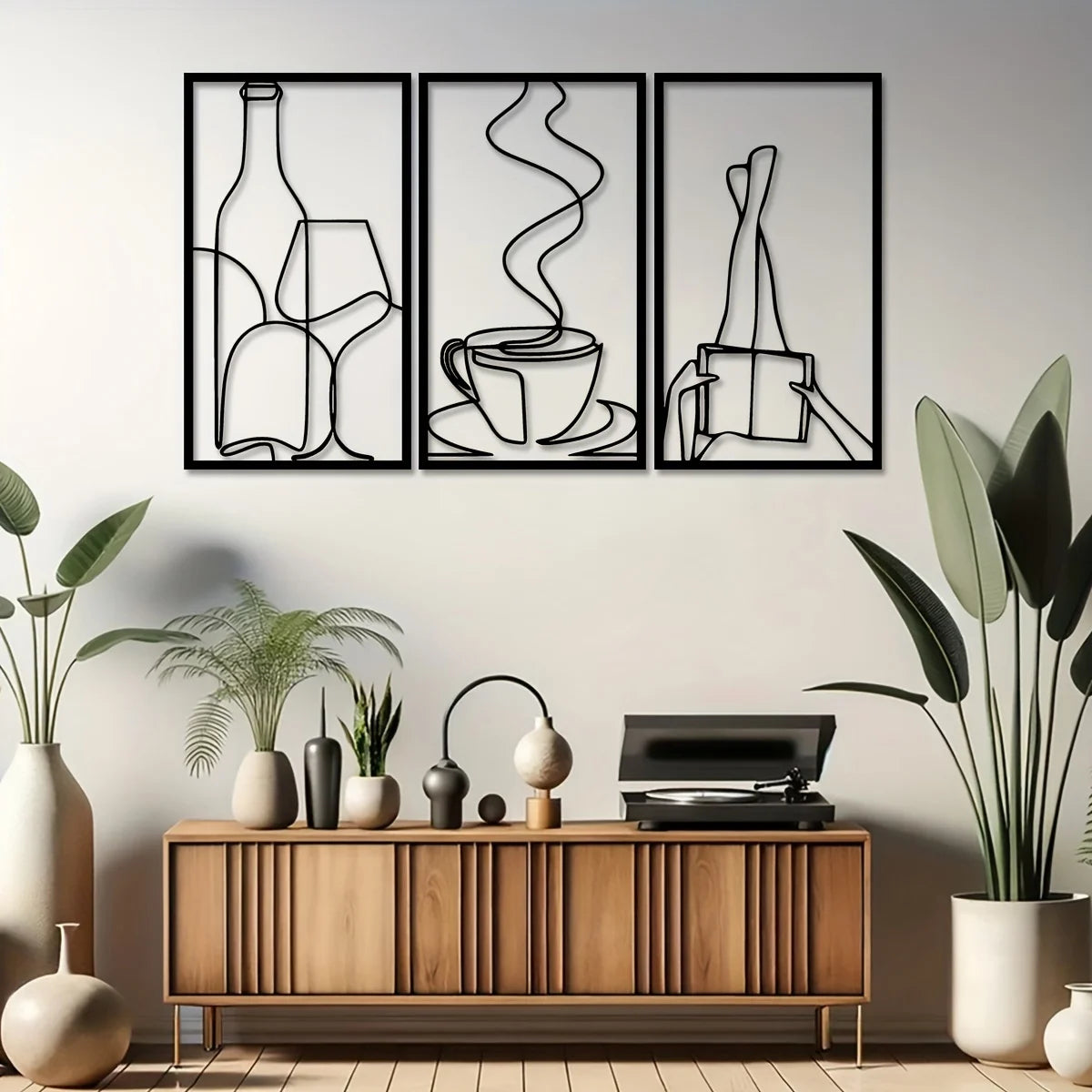 Three framed minimalist metal line drawings of a bottle, a cup, and a pencil on a light gray wall.