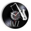 A black vinyl record-shaped wall clock featuring a silver saxophone design and the word JAZZ.