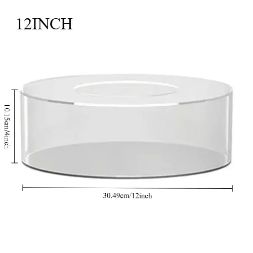 A clear acrylic cake display stand with a diameter of 12 inches and a height of 10.15 inches.