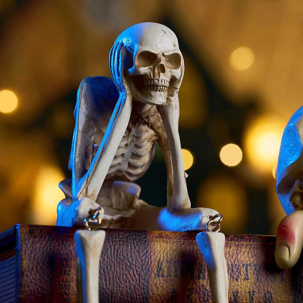 A white skeleton figurine set featuring a skull and skeletal structure, displayed on a brown leather surface.