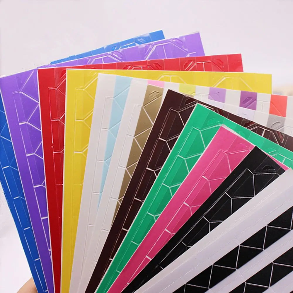 A stack of colorful PVC photo corner protectors in various shades including purple, red, yellow, and green.