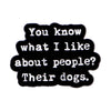 Black enamel pin with white text that reads You know what I like about people Their dogs.