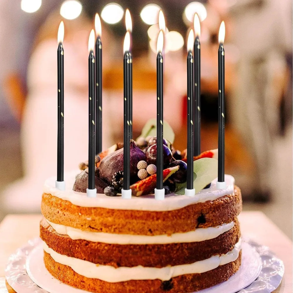 A tiered cake decorated with candles and fruit, featuring layers of light-colored frosting.