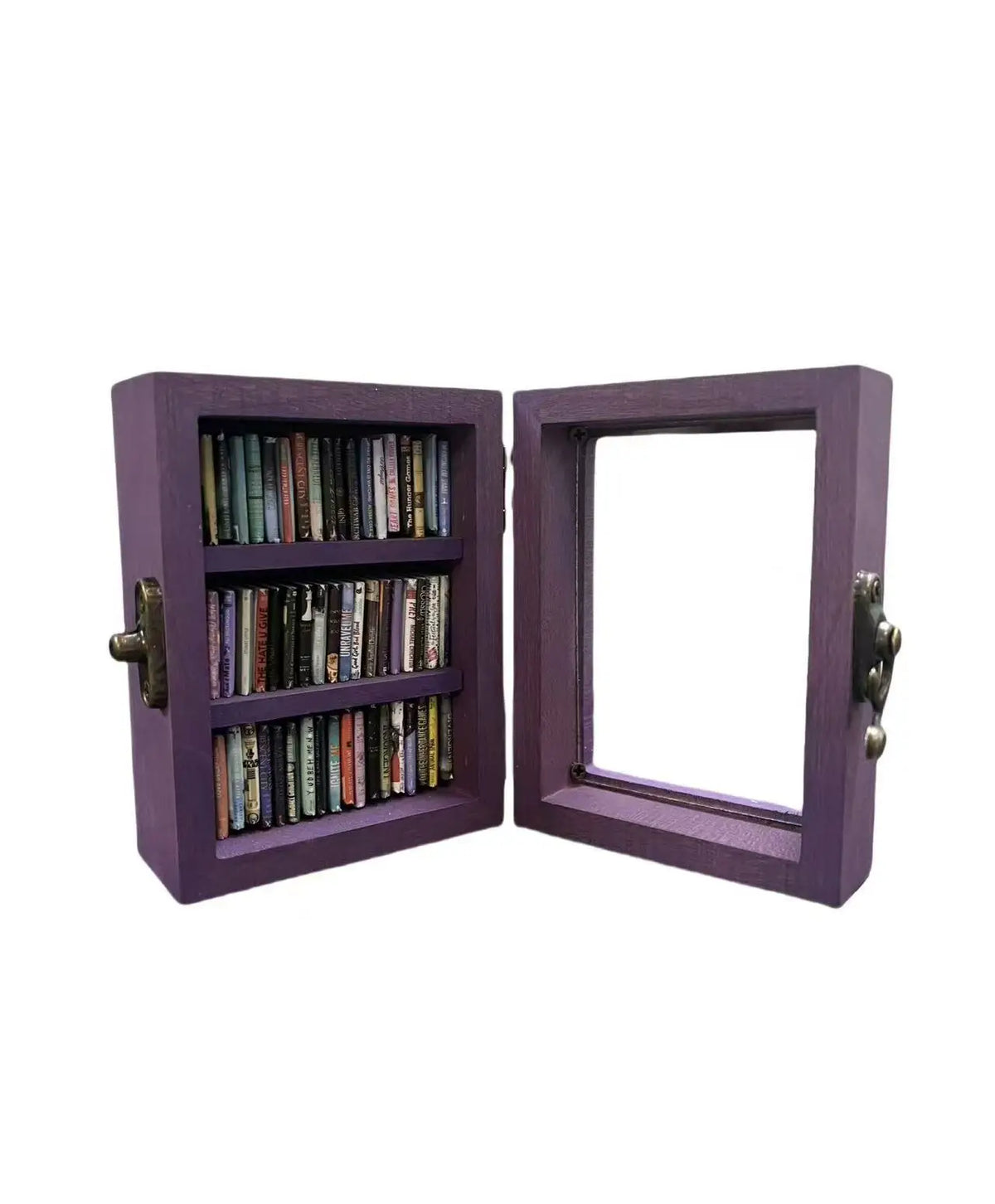 A purple wooden book display with a glass-fronted frame and a dark metal latch.