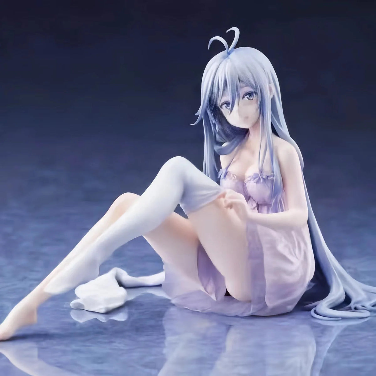 A figurine of an anime girl with long blue hair in a light purple dress sitting pose.