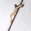 A resin figurine of Jesus on an Easter cross, carved from wood, displayed against a white background.