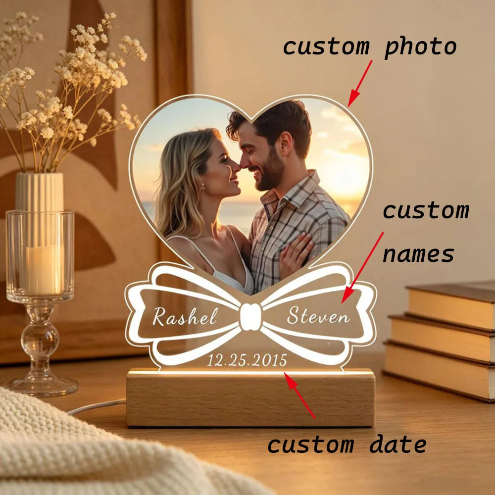 A personalized acrylic photo frame featuring a couple's photo, names, and custom date engraved on the base.