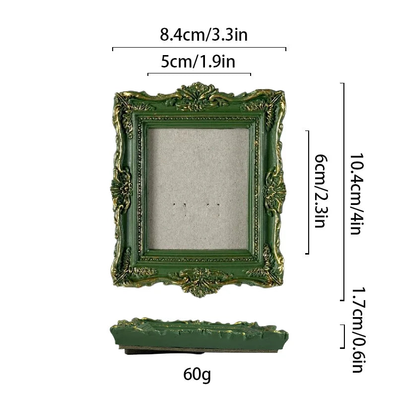 A vintage baroque green resin picture frame with ornate detailing and a clear glass insert.