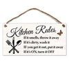 A wooden hanging sign with black text listing kitchen rules such as throwing away smelly items and turning off appliances.