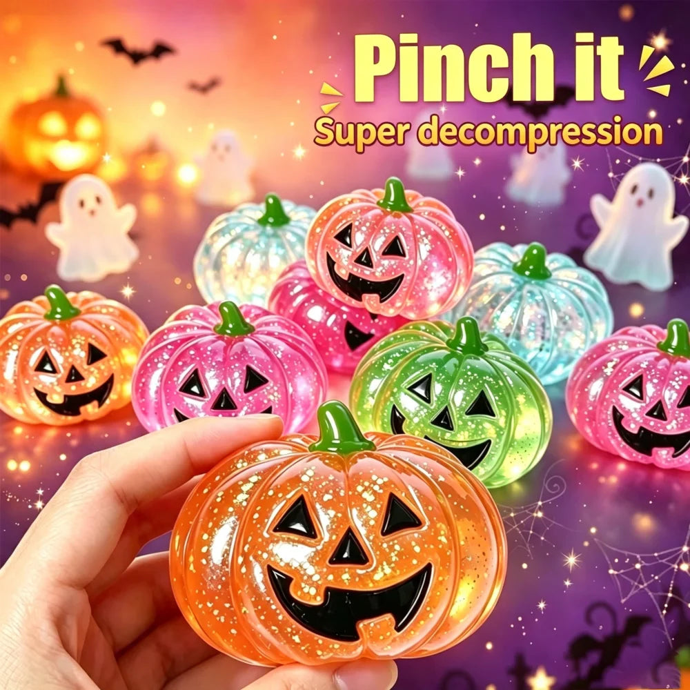 A hand holds an orange Halloween pumpkin stress ball with a carved face against a blurred background of other glowing pumpkin