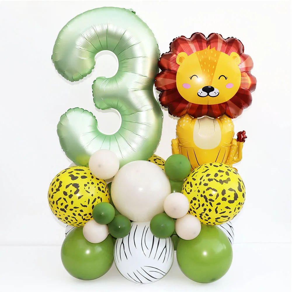 A set of green and yellow foil balloons shaped like the number three and a lion face for a birthday party