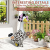 A decorative lawn goose costume set with black and white patterned fabric standing on a wooden deck.