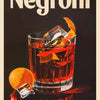 A glass of Negroni with ice and an orange peel sits on a dark surface against a black background.