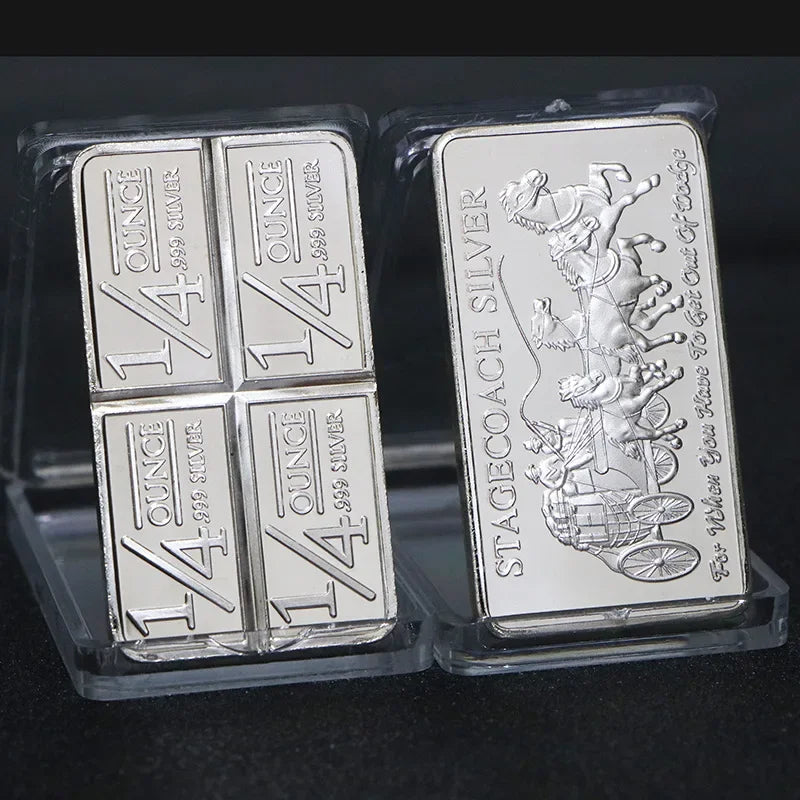 A collection of silver bullion bar replicas, including a 1/4 ounce silver bar and a stagecoach silver bar.